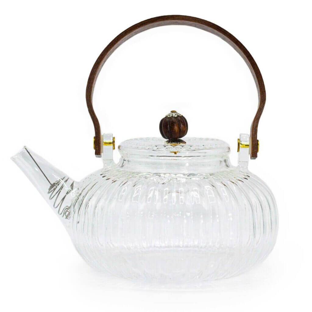 Clear glass teapot with a ribbed design, short spout, round wooden handle, and matching wooden knob on the lid.