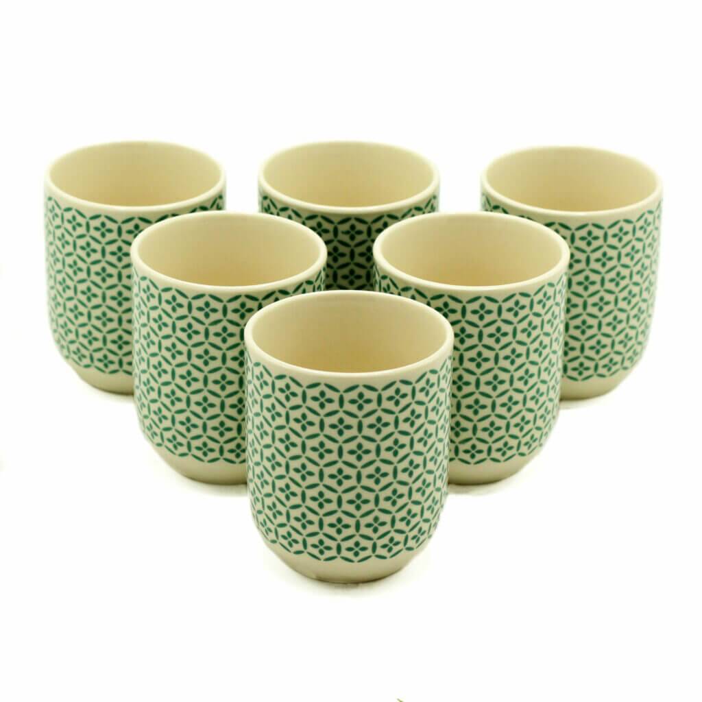 Six ceramic cups with a green geometric pattern are arranged in two rows on a white background.