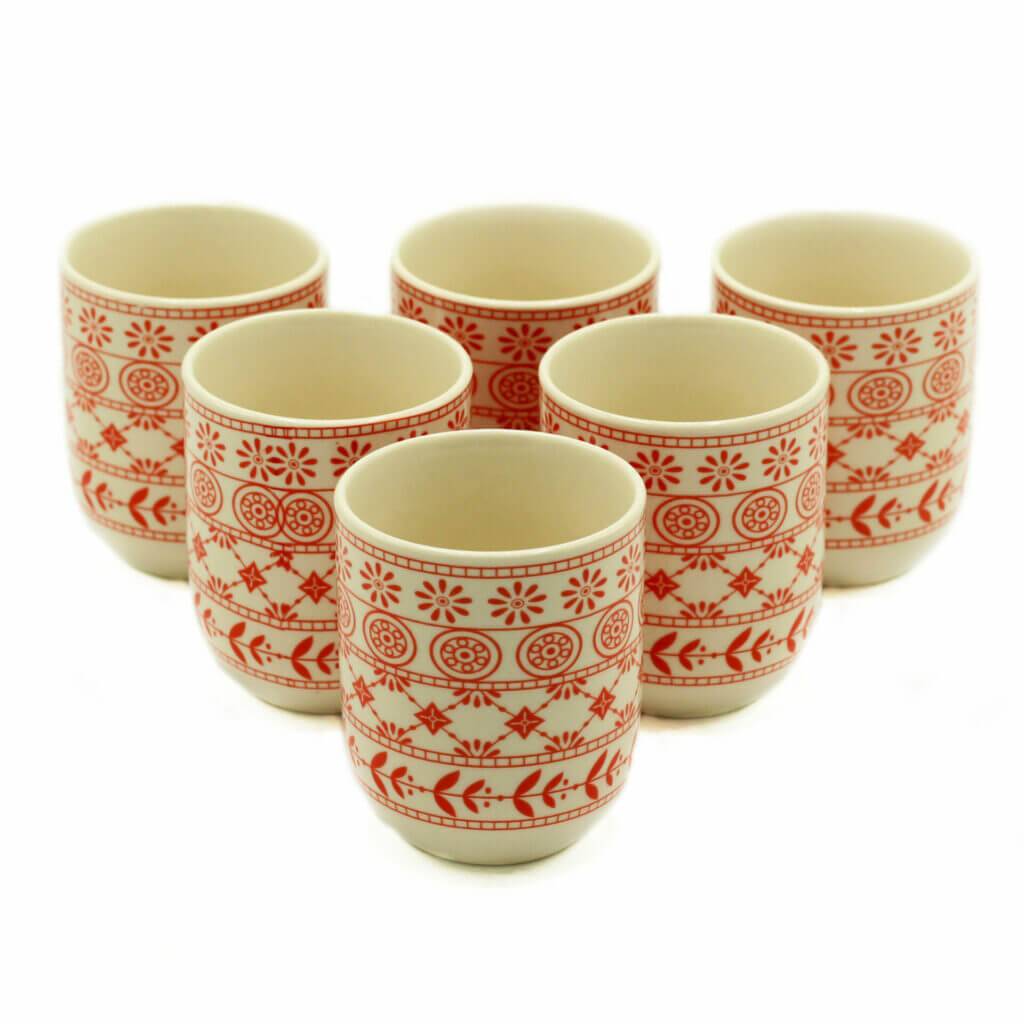 Six ceramic cups with red geometric and floral patterns arranged in two rows on a white background.