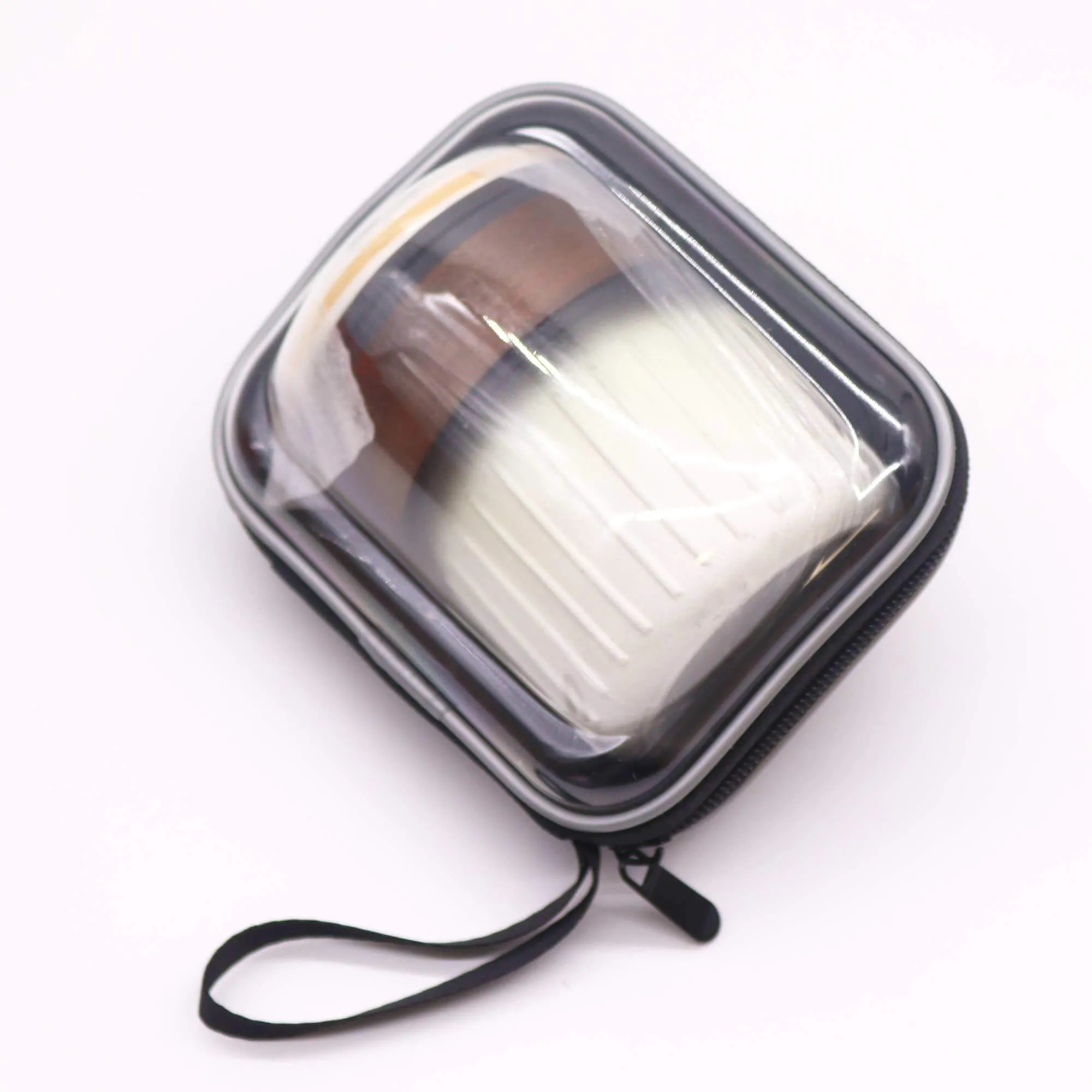 A clear zippered carrying case containing a white and brown cylindrical object with a ribbed texture, set against a white background.