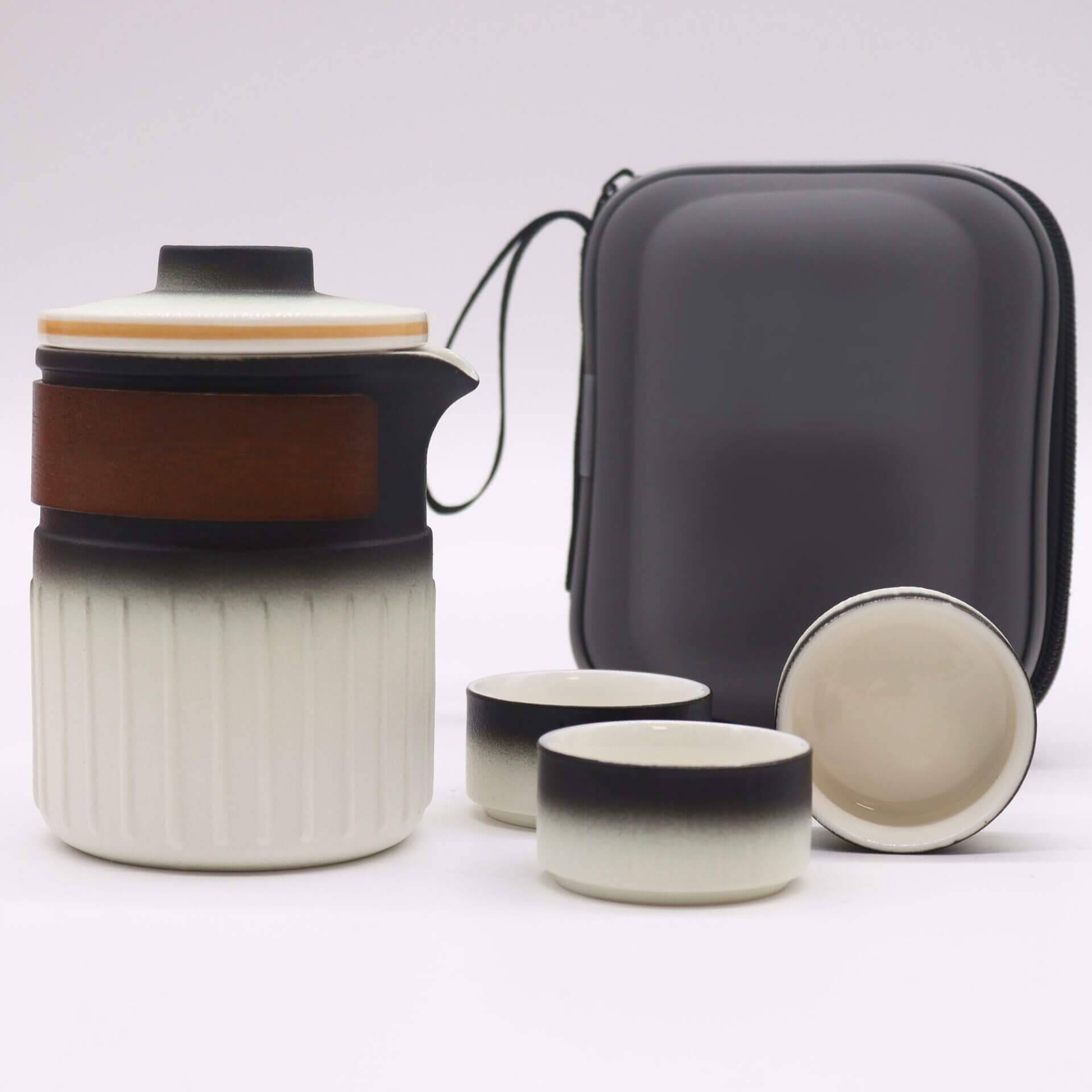A ceramic travel tea set with a lidded teapot, three cups, and a zippered carrying case displayed on a white background.