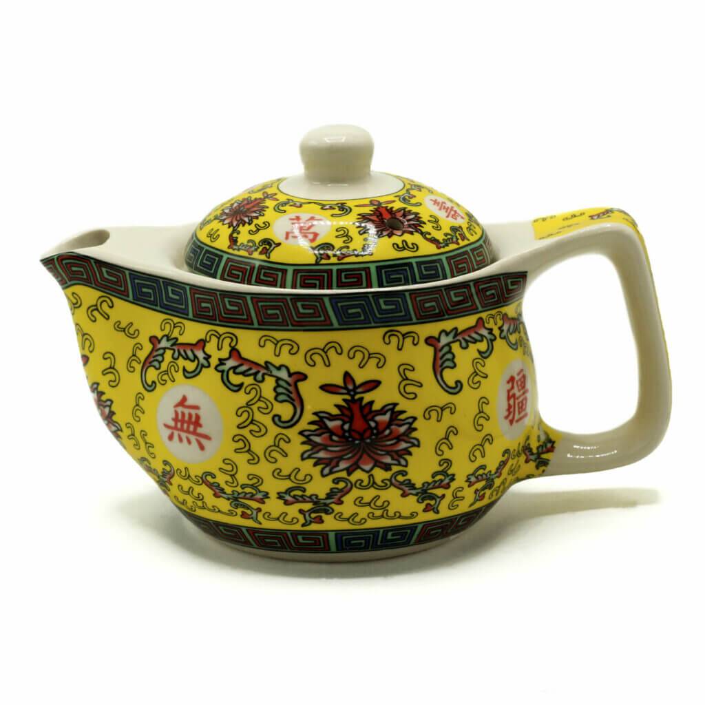 A yellow ceramic teapot with a square handle, decorated with floral patterns, geometric borders, and red Chinese characters.