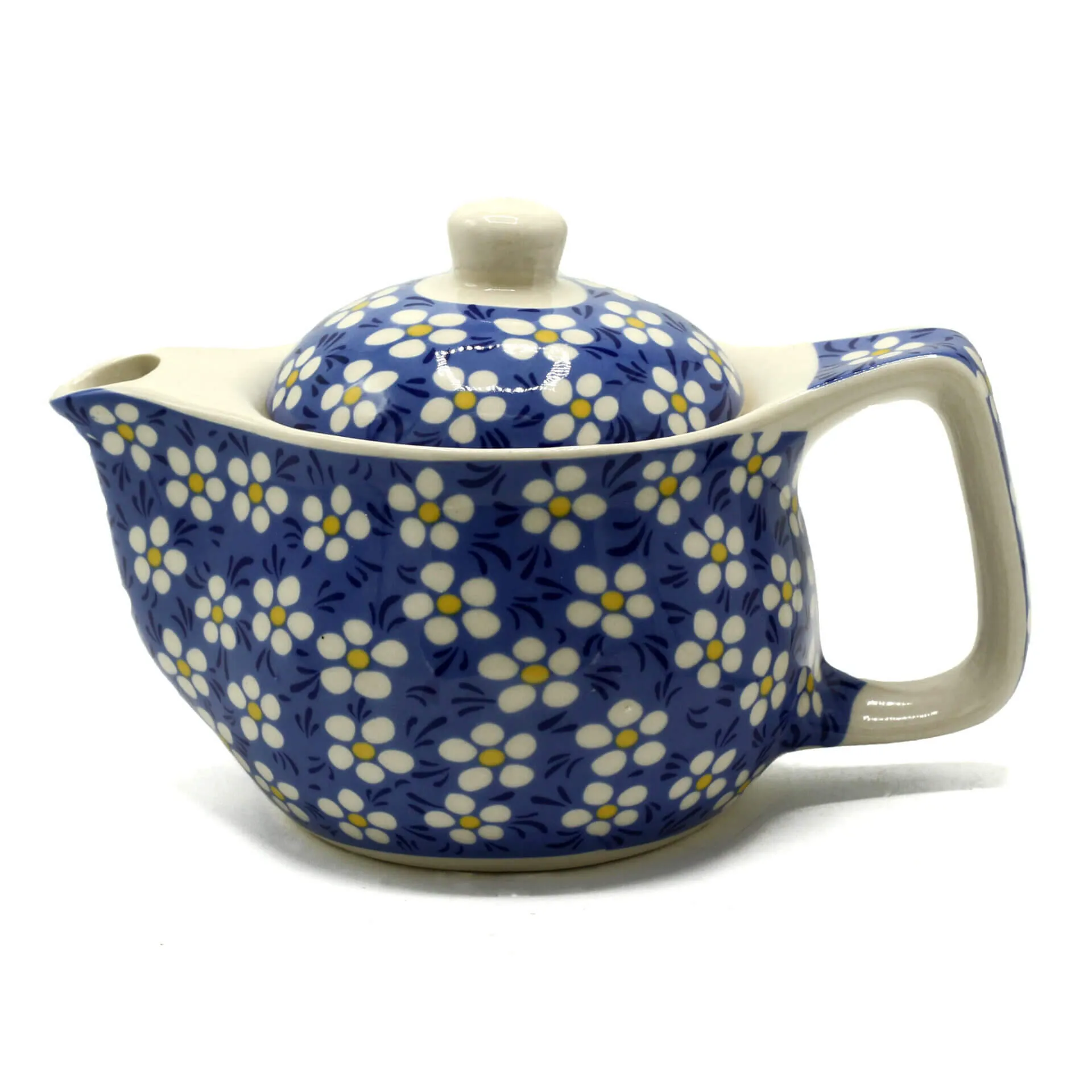 A ceramic teapot with a blue background and white and yellow floral pattern, featuring a large handle and matching lid.