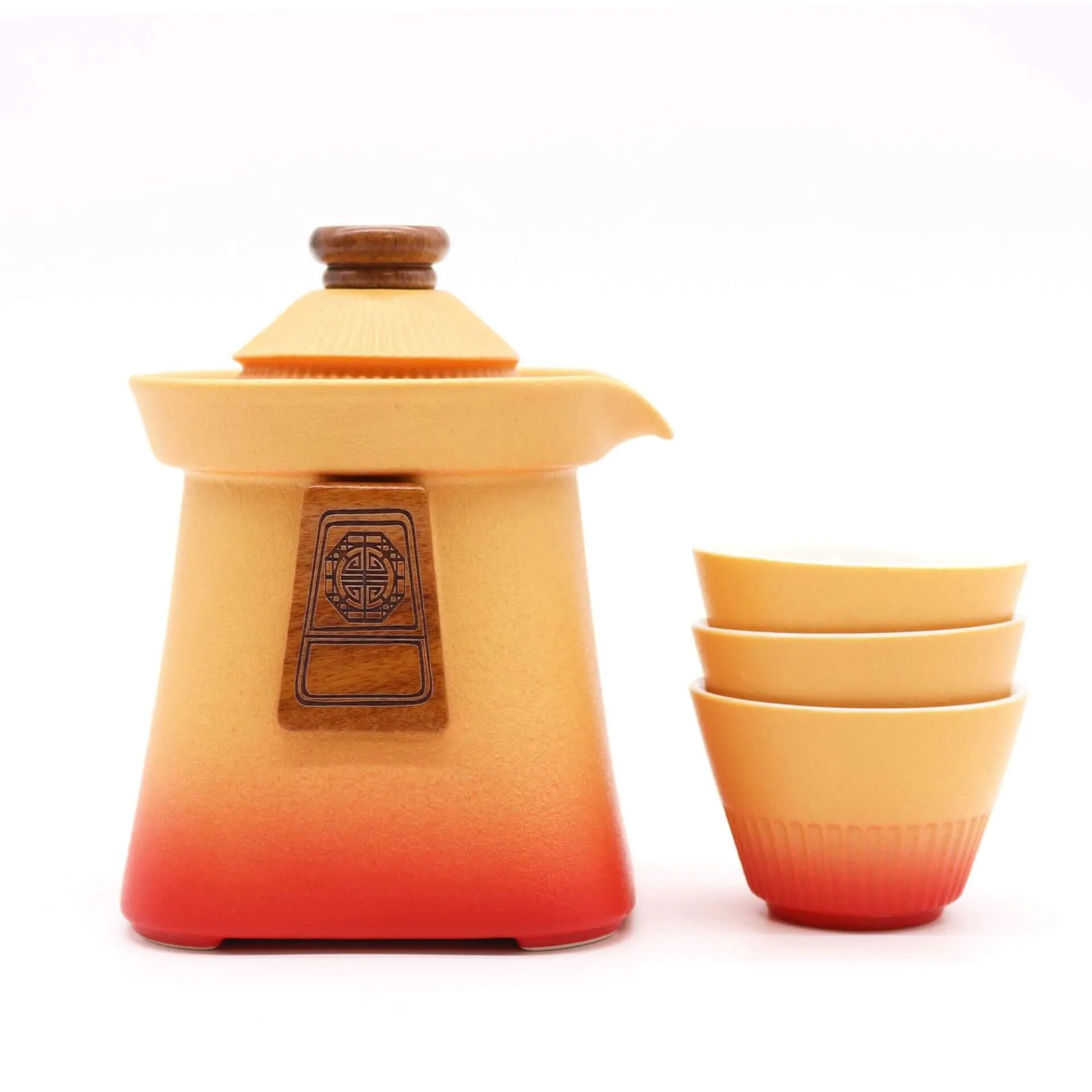 A ceramic teapot with a wooden lid and three matching stacked cups, all in a gradient orange and yellow color, are set against a plain white background.
