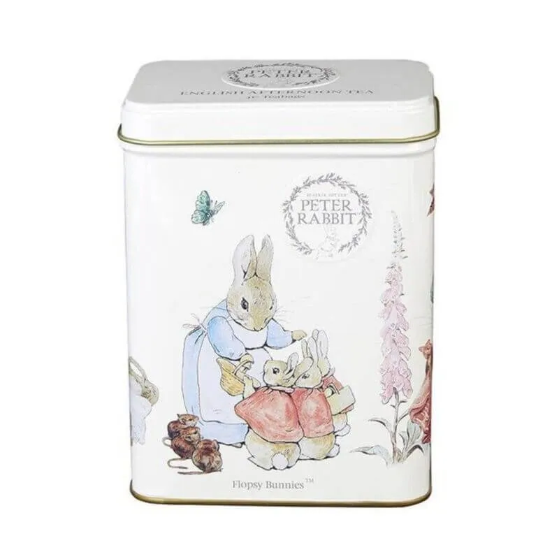 This charming white tin, branded with Beatrix Potter's beloved illustration, features the Flopsy Bunnies™, rabbits in clothing, flowers, a butterfly, and a bear. It's perfect for storing teabags and is ideal for fans of whimsical storytelling.