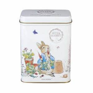 White metal tin with Beatrix Potter's illustration of Peter Rabbit in a garden holding a carrot amid lush plants and a flower pot. Contains 40 English Breakfast teabags.