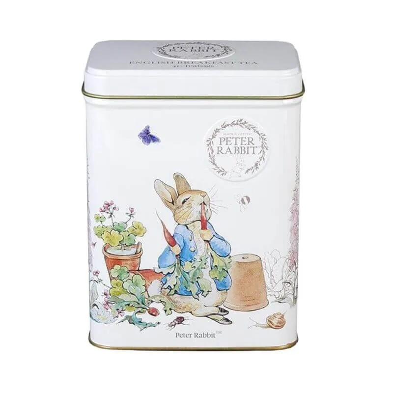 White metal tin with Beatrix Potter's illustration of Peter Rabbit in a garden holding a carrot amid lush plants and a flower pot. Contains 40 English Breakfast teabags.