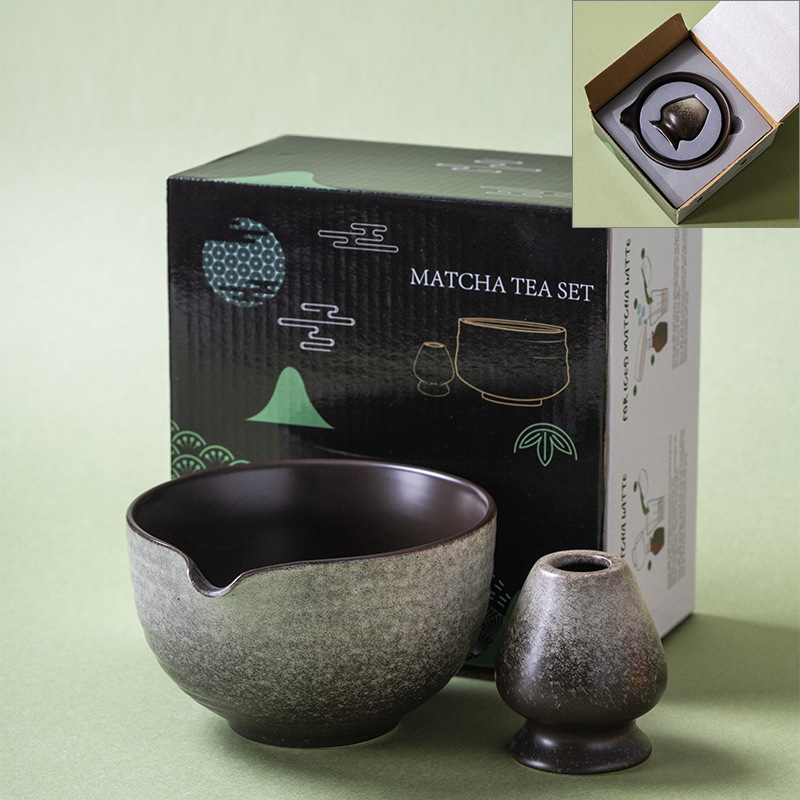 A Kiln-Glazed Matcha Bowl & Whisk Holder Set – 2 Piece | Stone sits before a box labeled 