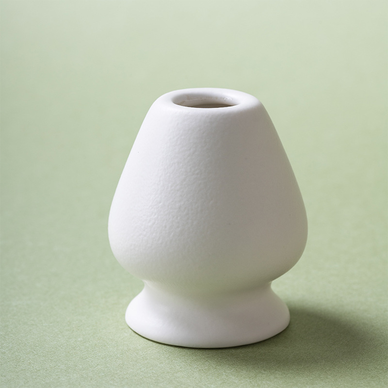 Ceramic chasen holder in matte white stoneware for bamboo matcha whisk, clean, minimal, hand-finished.