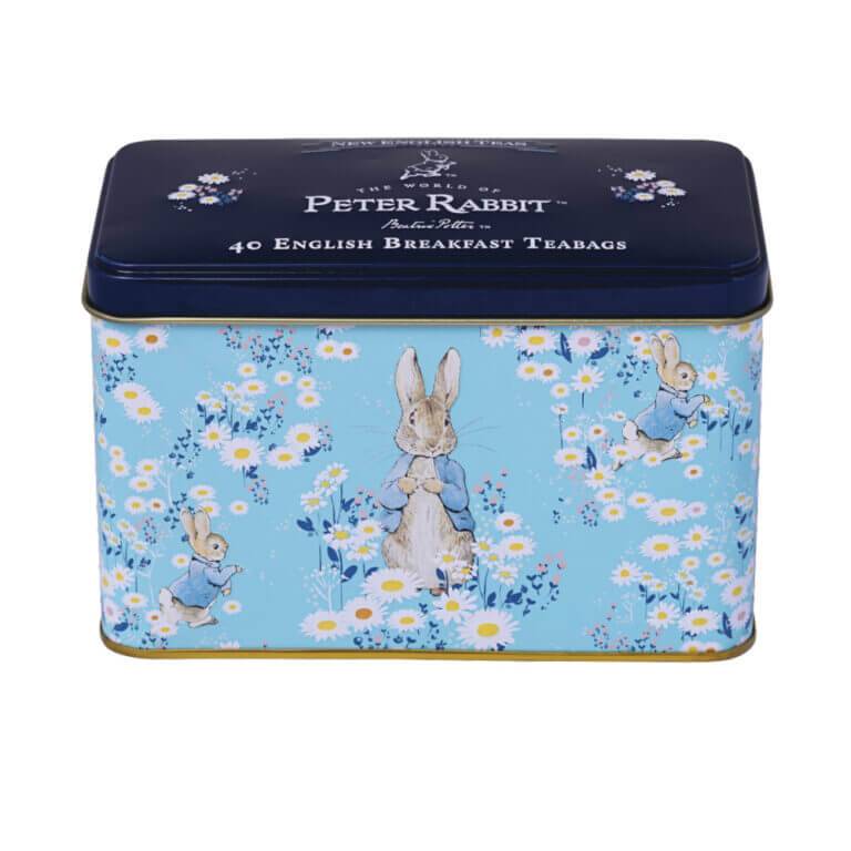 This decorative tin, named "Beatrix Potter - Daisies," features Peter Rabbit illustrations on a blue floral background and contains 40 English Breakfast teabags.